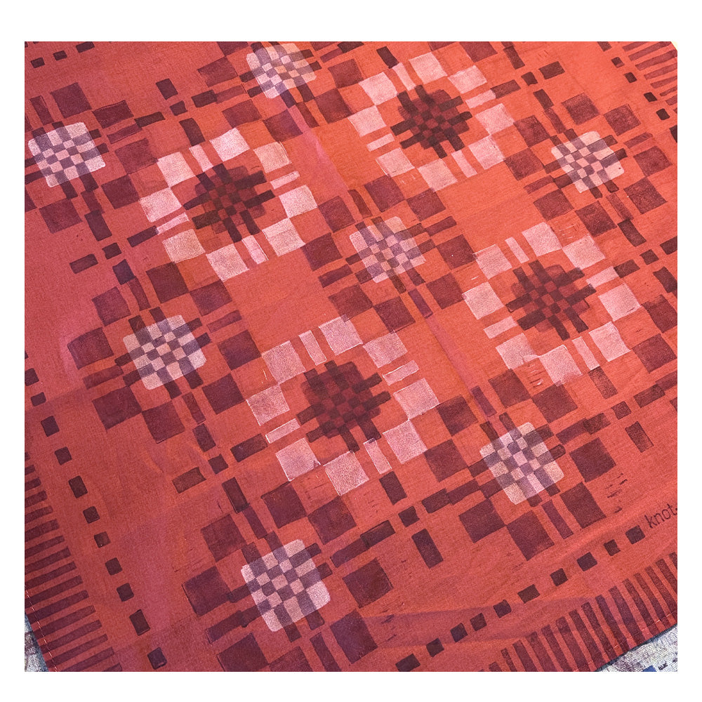 Vibrant red patterned bandana with a modern patchwork design, lay flat detail photo