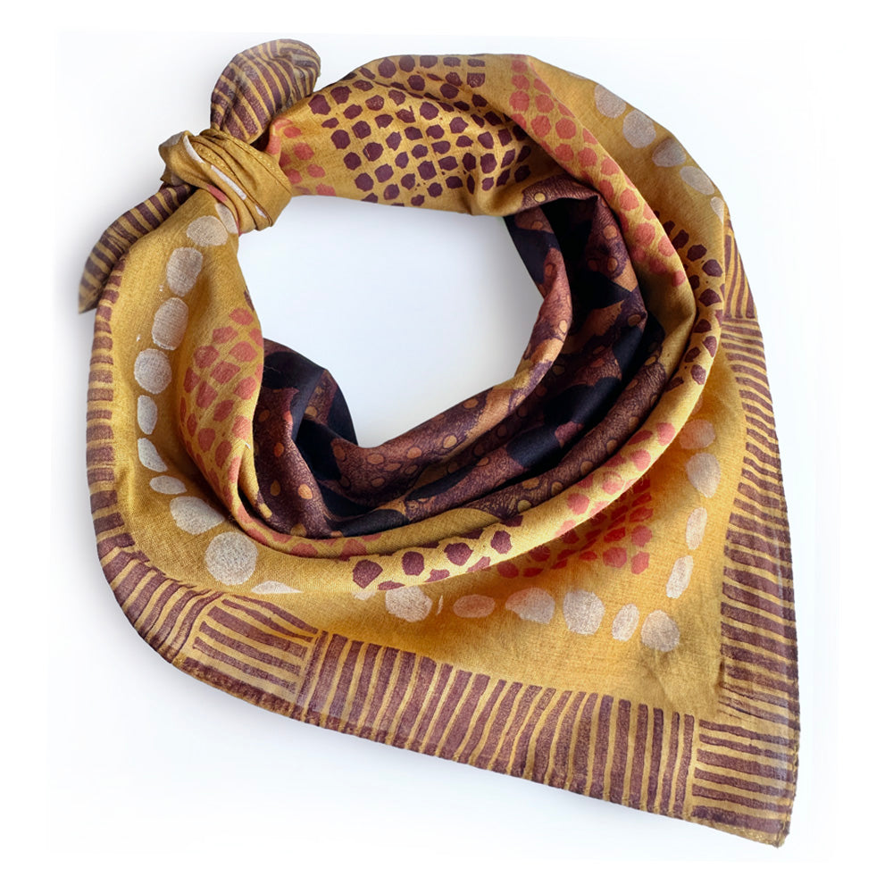 Patterned scarf with earthy tones on a white background