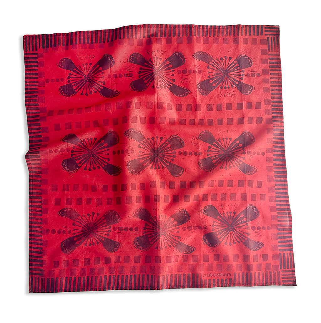 Warm Red bandana with deep purple floral pattern on a white background